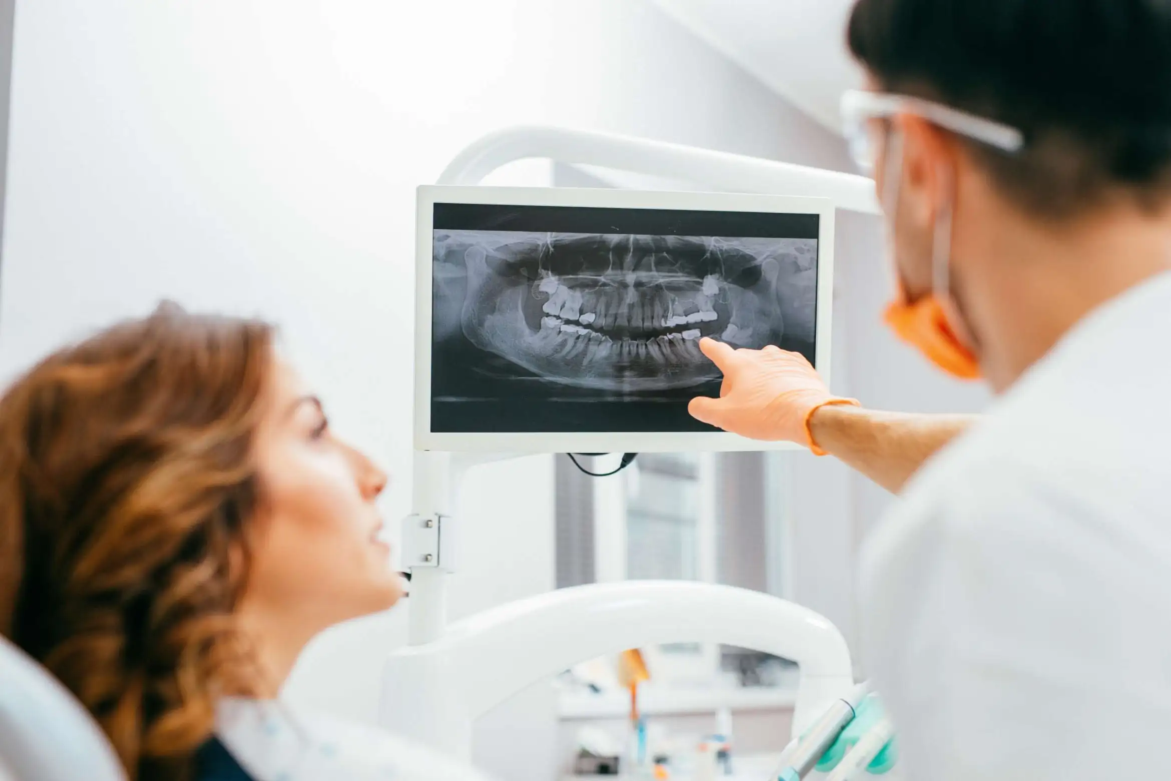 Dentist reviewing a digital dental X-ray with a patient